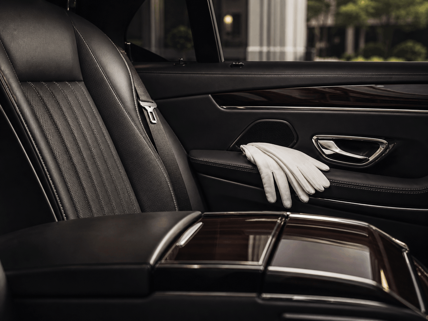 Premium vehicle interior with handmade leather details and chauffeur gloves